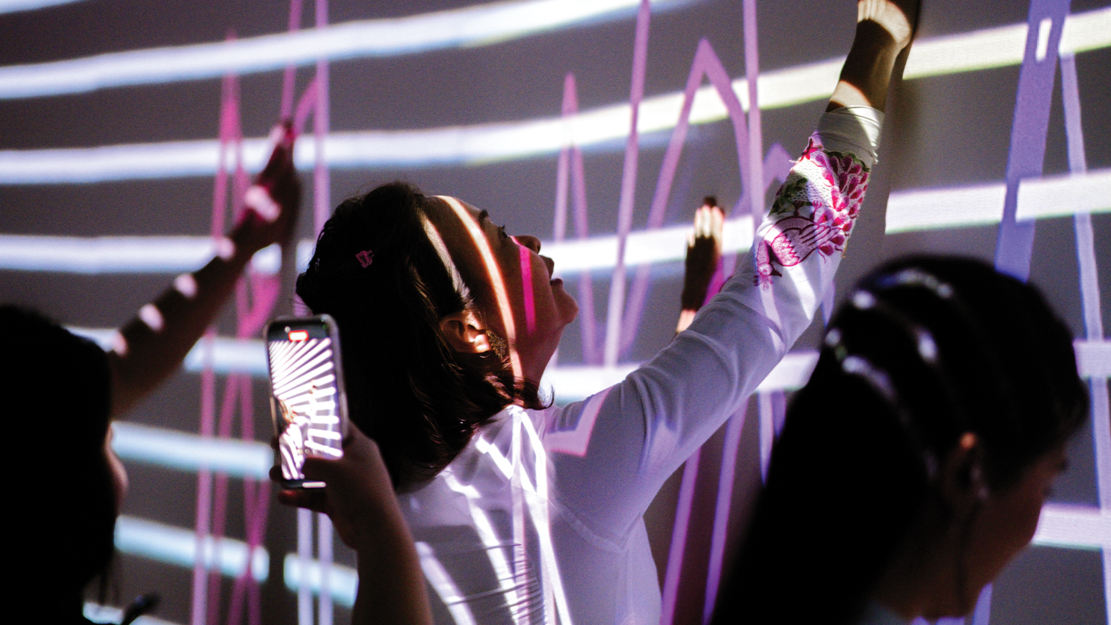 IKAT Malaysia exhibition — visitors interacting with the immersive heritage display